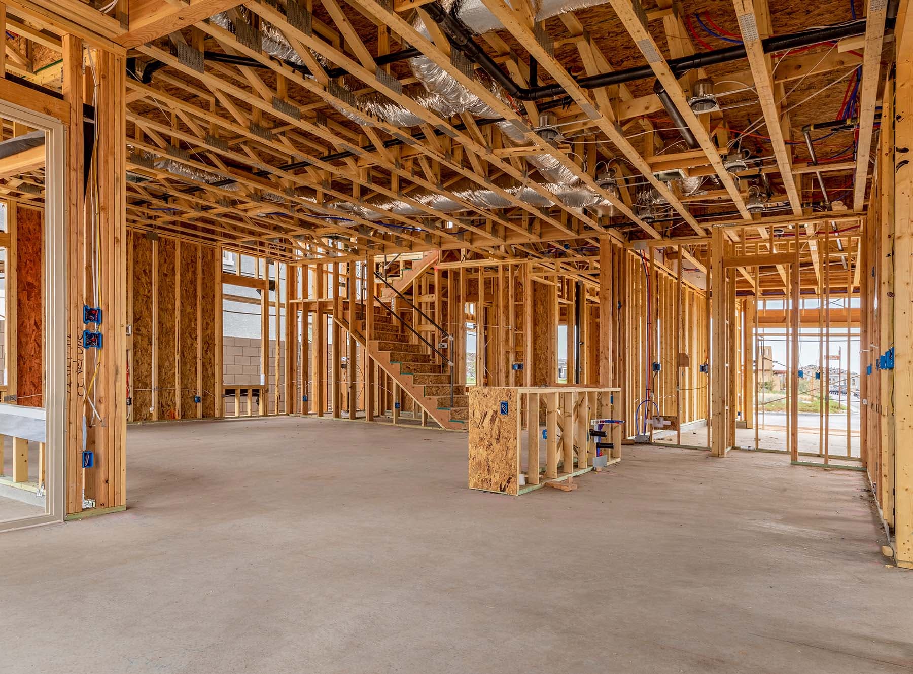 The interior of a half built house, showing the wooden posts and joists.